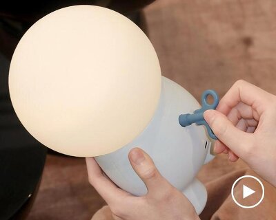 buddy portable mood lamp encourages interaction through a single wind-up key
