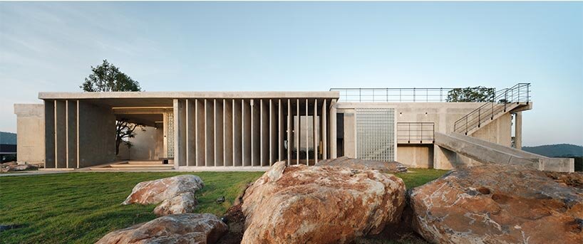 repetitive vertical fins enfold concrete structure embedded within thailand&rsquo;s mountainscape - 1