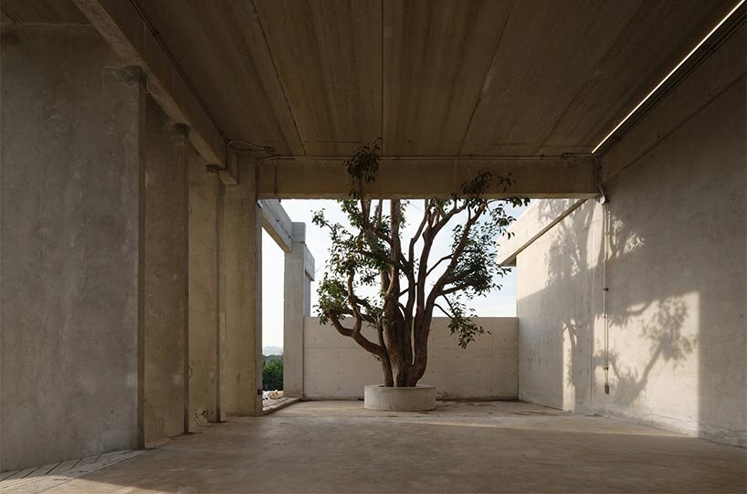 repetitive vertical fins enfold concrete structure embedded within thailand&rsquo;s mountainscape - 5