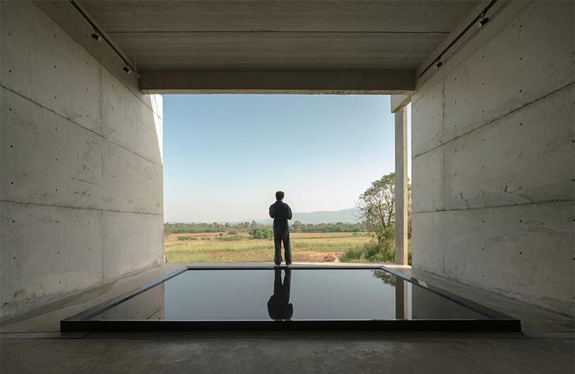 repetitive vertical fins enfold concrete structure embedded within thailand&rsquo;s mountainscape - 6