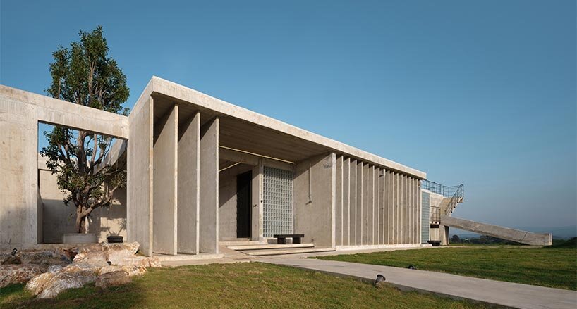 repetitive vertical fins enfold concrete structure embedded within thailand&rsquo;s mountainscape - 2