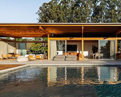 oversized boulders and native trees determine footprint of timber pavilion in brazil