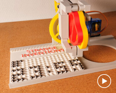 mechanical marble clock moves steel balls into pixel-like digits to tell the time