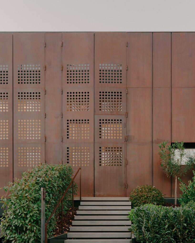 punctured iron doors shape kinetic facade by TIMM architecture in tbilisi - 5