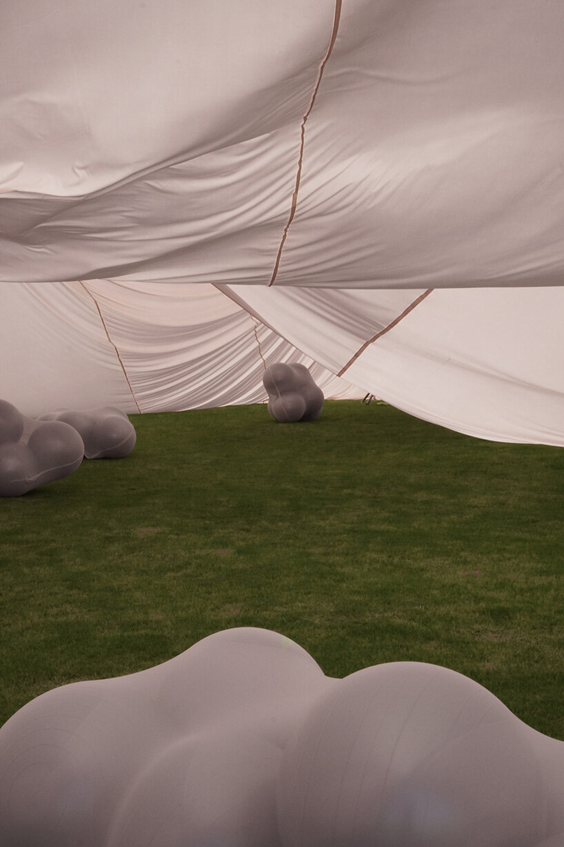 red balloons lift flowing fabric into a wedding playground by suki+partners in china - 12