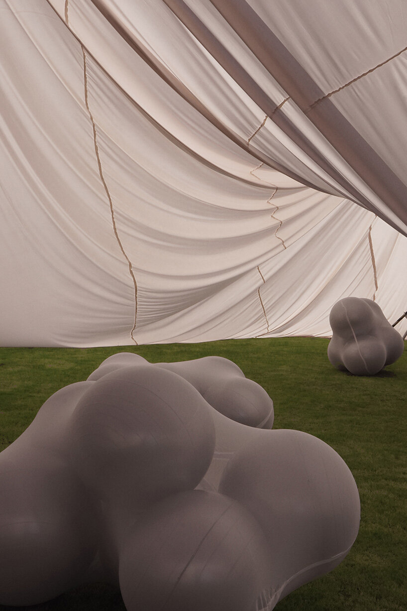 red balloons lift flowing fabric into a wedding playground by suki+partners in china - 13