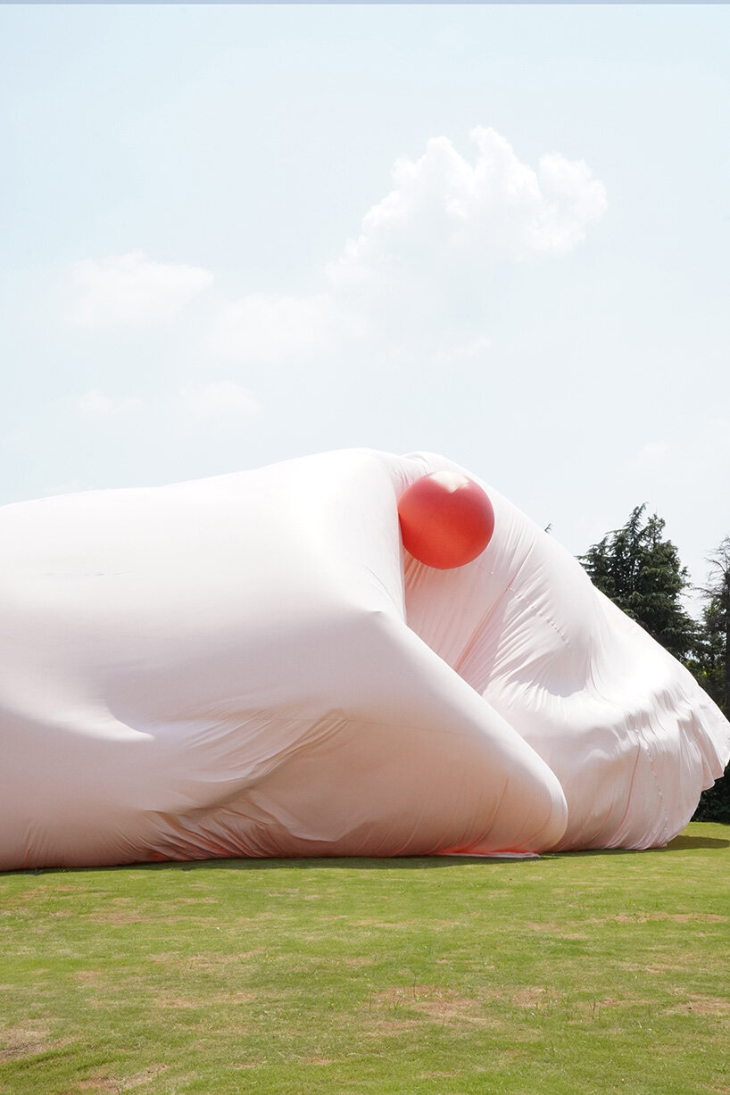 red balloons lift flowing fabric into a wedding playground by suki+partners in china - 4
