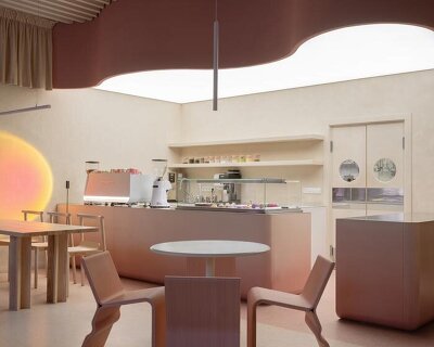 curved pink interiors animate hybrid retail-café space within brick shell