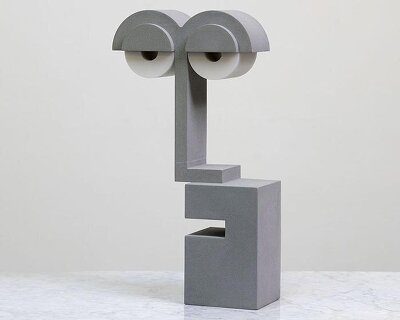 a playful bauhaus nightlight that looks half asleep forms out of hand-cast concrete