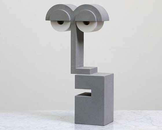 a playful bauhaus nightlight that looks half asleep forms out of hand-cast concrete