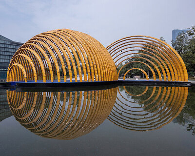 arching, bamboo-like pavilion of glazed ceramic tiles by H&P architects rises in hanoi