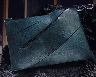 collagen from dinosaur shapes the designer handbag made with lab-grown leather