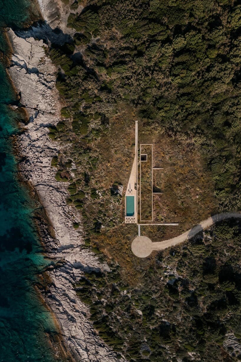linear stone residence emerges within greek island’s untouched coastal terrain - 3