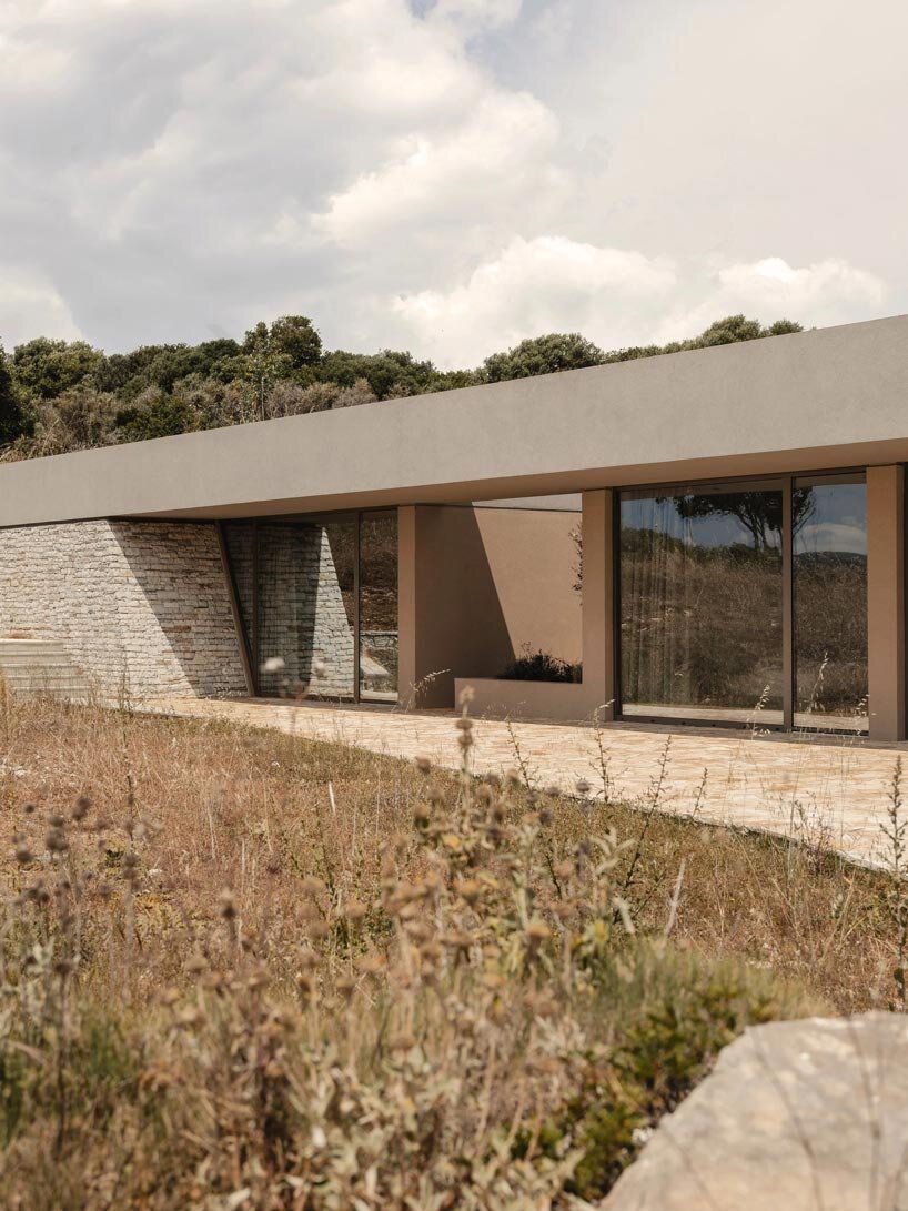 linear stone residence emerges within greek island’s untouched coastal terrain - 5