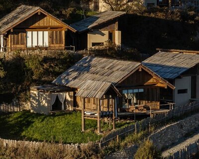 reclaimed timber reassembles a cluster of cabins into a mountain resort in china