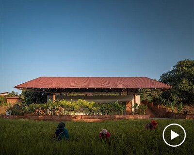 gabled roof floats over gathering pavilion’s brick stepped plinths in india