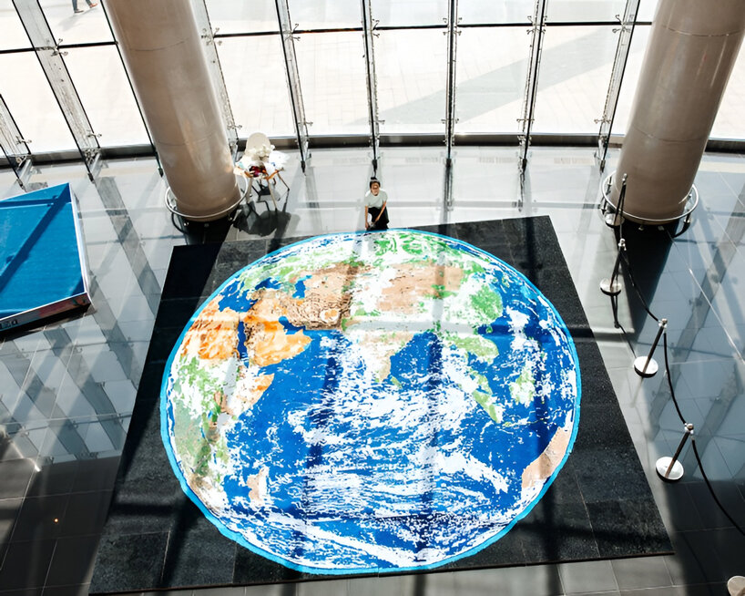 thousands of hand-rolled paper quills compose monumental mosaic earth artwork - 10