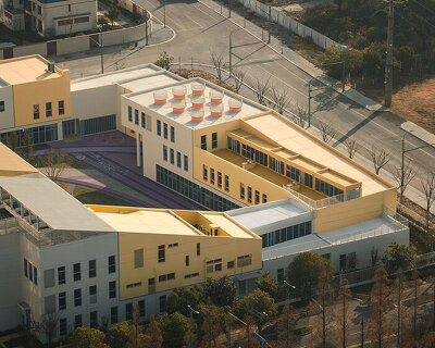 stacked color blocks and layered courtyards form a modular castle-like kindergarten in china
