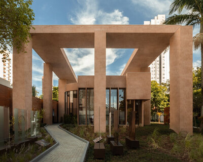 monochromatic concrete geometry shapes temporary pavilion in são paulo