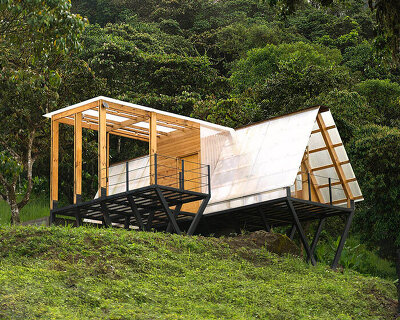 translucent polycarbonate skin envelopes triangular shelter elevated on stilts in ecuador