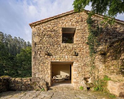 vernacular stone cabin in northern spain gains a renewed layered inner envelope