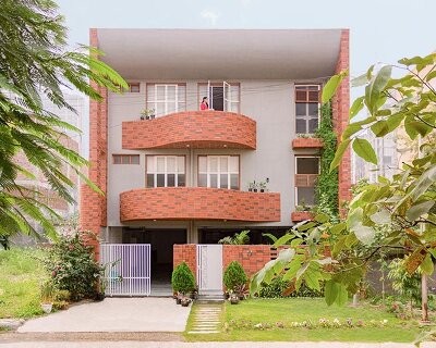 curved balconies clad in brick tiles outline a multi-generational indian home