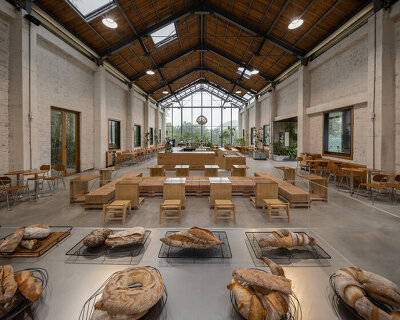 stone-oven bakery and restaurant reconfigures 1970s auditorium in rural china