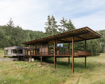 olson kundig's 'daisy ranch' is a modern log cabin with panoramic glazing in british columbia
