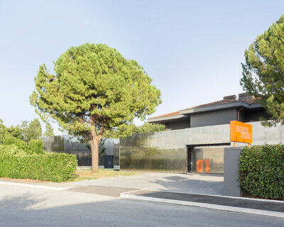 mirrored aluminum facade blurs distretto solidale social space into the italian landscape