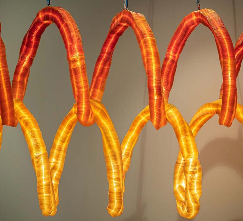 seaweed-based biodegradable material shapes two interlocking tubular light installations - 9