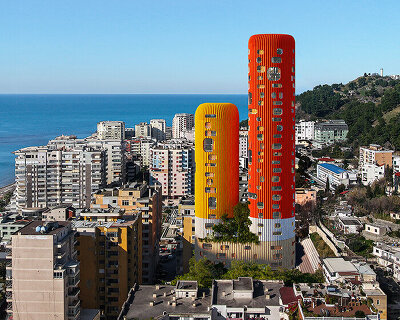 selgascano's sky-K rises as two colorful residential 'chimneys' along the coast of albania