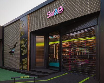 monochrome surfaces and neon accents outline swag golf bangkok flagship