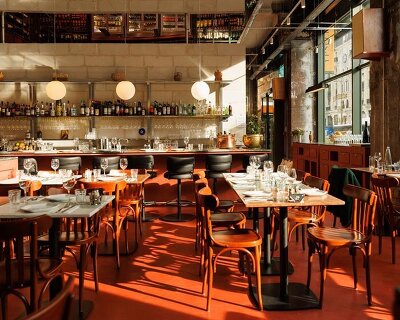 red floor anchors parisian restaurant ypseli with steel and marble textures