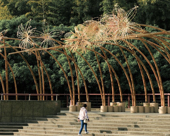woven bamboo canopy forms floral field bending over sunken urban plaza in shanghai
