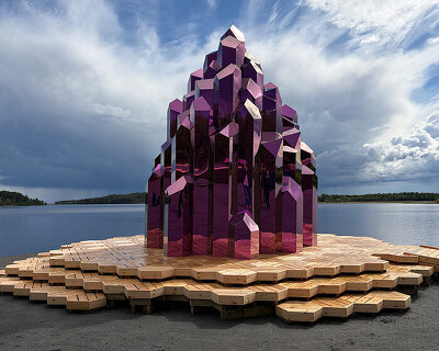 lithium crystal forms inspire this mirrored pink sauna on sweden's reclaimed wasteland