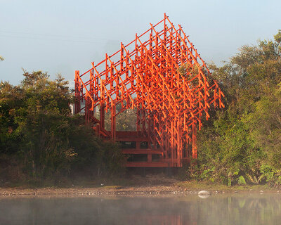 an intricate timber viewpoint by dum-dum lab rises beside chile's laguna troya