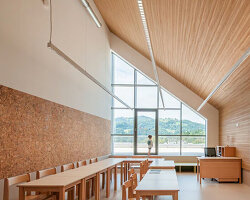concrete and beech shape flexible learning spaces within school and social hub in slovenia