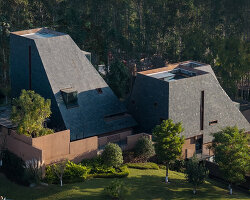 line+ embeds a cluster of sculptural roofed volumes within red-earth valley in china