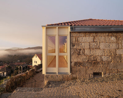 a fire-scarred house becomes a social center overlooking the spanish village of muimenta