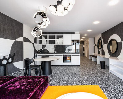 circle meets square in hotel suite interior defined by black-and-white wall compositions