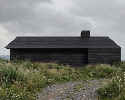 monolithic black timber retreat frames panoramic views of ukraine's carpathian mountains