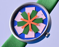 kinetic watch dial reimagines timekeeping through layered colored star-like hands