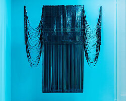 VHS tapes and cassette recordings replace yarn in a woven archive of collective memory