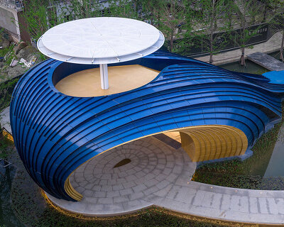 blue aluminum panels curve to shape a whale-like entrance gate by wutopia lab