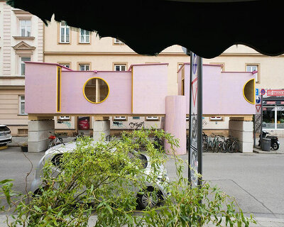 pink timber room rises over munich bike racks as urban lab 'zuhaus'