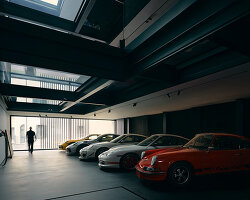 black resin, glass, and steel shape alessandro isola's automotive sanctuary in italy
