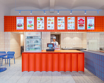 blue, red, and orange interiors bring seoul’s visual energy to the kimchi restaurant in prague