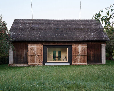 black asphalt and birch plywood shape compact retreat within czech barn