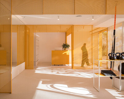 bright orange perforated metal sheets shape a modular fitness center in madrid