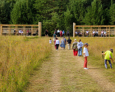 as contemporary propylaea, twin timber gateways frame this open-air architectural park
